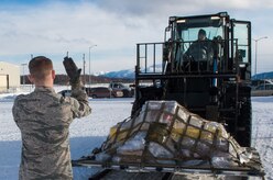 Senior Airman Brian Wood, 673d Logistics Readiness Squadron vehicle maintenance journeyman, marshals Airman 1st Class John Figueirdo, 673d LRS vehicle maintenance apprentice, during a mobility exercise at Joint Base Elmendorf-Richardson, Alaska, March 9, 2018. Mobility exercises are designed to bridge the gap between semi-annual POLAR FORCE exercises. They enhance readiness and training, while providing teachable moments to augmentees tasked to support cargo-processing.
