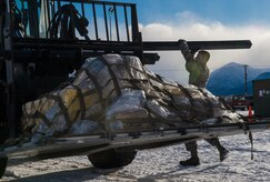 Senior Airman Brian Wood, 673d Logistics Readiness Squadron vehicle maintenance journeyman, removes chocks from a forklift during a mobility exercise at the Joint Mobility Center at Joint Base Elmendorf-Richardson, Alaska, March 9, 2018. Mobility exercises are designed to bridge the gap between semi-annual POLAR FORCE exercises. They enhance readiness and training, while providing teachable moments to augmentees tasked to support cargo-processing.