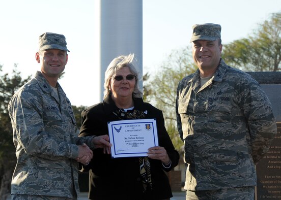 U.S. Air Force Col. Anthony Krawietz, wing commander for 97th Air Mobility Wing, and Col. Michael Griener, commander for 97th Mission Support Group, induct Barbara Burleson, a former honorary commander for the 97th Civil Engineer Squadron, as the 97th MSG Honorary Commander, Nov. 29, 2012, at Altus Air Force Base, Okla.