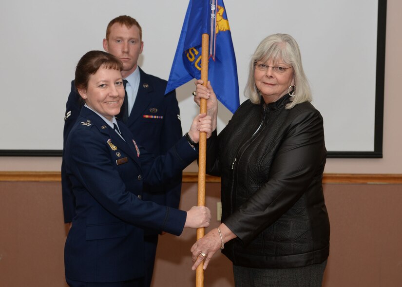 U.S. Air Force Col. Terri Jones, commander of the 97th Mission Support Group, inducts Barbara Burleson, a former honorary commander for the 97th Civil Engineer Squadron, as the 97th MSG Honorary Commander, Jan. 26, 2015, at Altus Air Force Base, Okla.