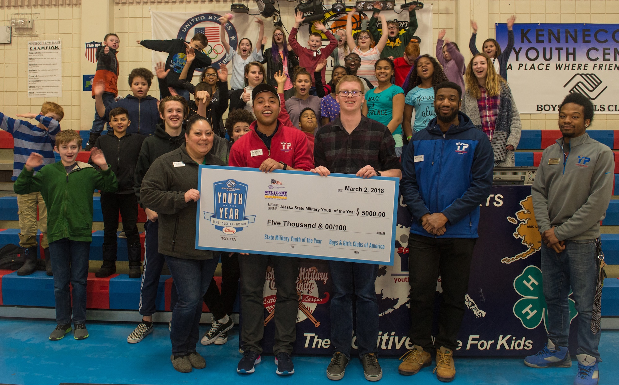 Jon Peterson and youth at the Kennecott Youth Center pose for a photo at Joint Base Elmendorf-Richardson, Alaska, March 7, 2018. Jon was recognized as this year’s Boys and Girls Clubs of America Military Youth of the Year for the state of Alaska and awarded a $5,000 scholarship. The program is designed to promote service to club, community and family, academic success, strong moral character, life goals and poise and public speaking. Jon will now compete at the Pacific Air Forces regional level for a chance to win a $40,000 scholarship and an invitation to compete at the national level.