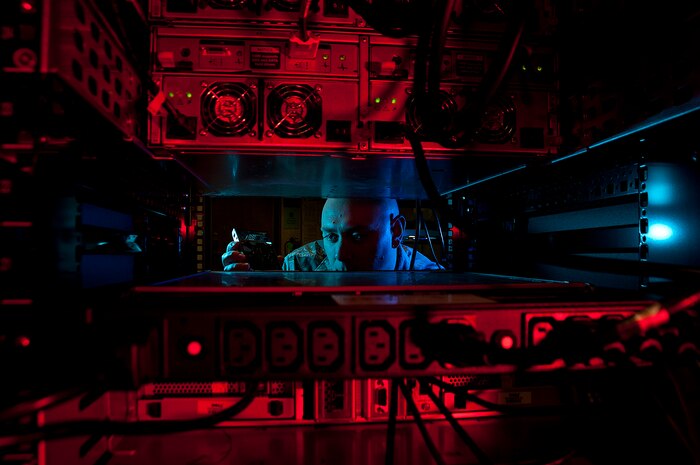 Air Force Staff Sgt. Jerome Duhan, a network administrator with the 97th Communications Squadron, inserts a hard drive into the network control center retina server at Altus Air Force Base, Okla.