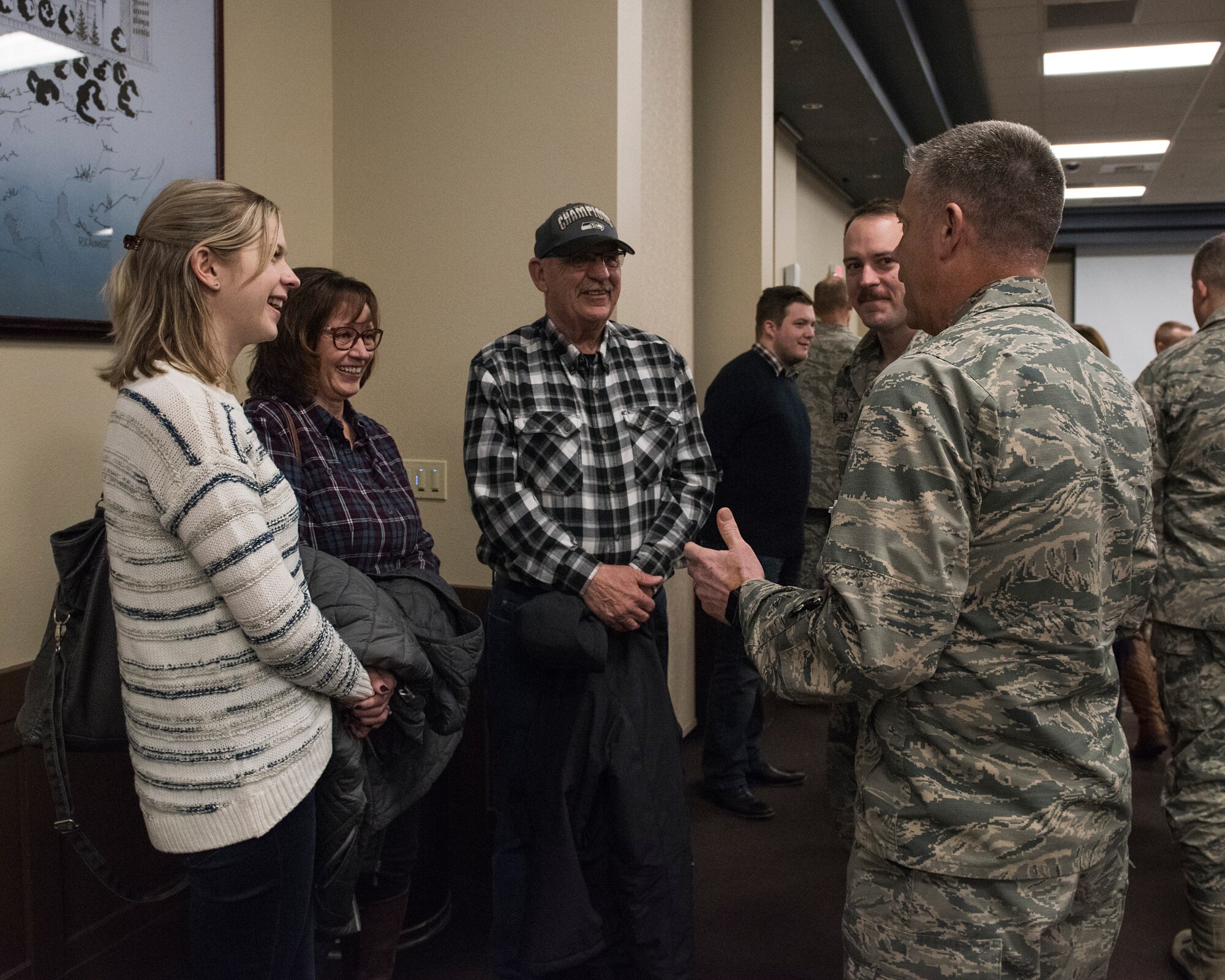 Brig. Gen. Jeremy Horn, Commander, Washington Air National Guard, speaks with the family of Tech. Sgt. Andrew Luiten, a radio frequency transmission systems specialist with the 242nd Combat Communications Squadron, March 3, 2018 at Fairchild Air Force Base, Wash. Luiten was one of more than 30 Airmen from the 242nd CBCS who recently returned home from a six-month deployment in Southwest Asia in support of Operation Inherent Resolve. (U.S. Air National Guard photo by Staff Sgt. Rose Lust)