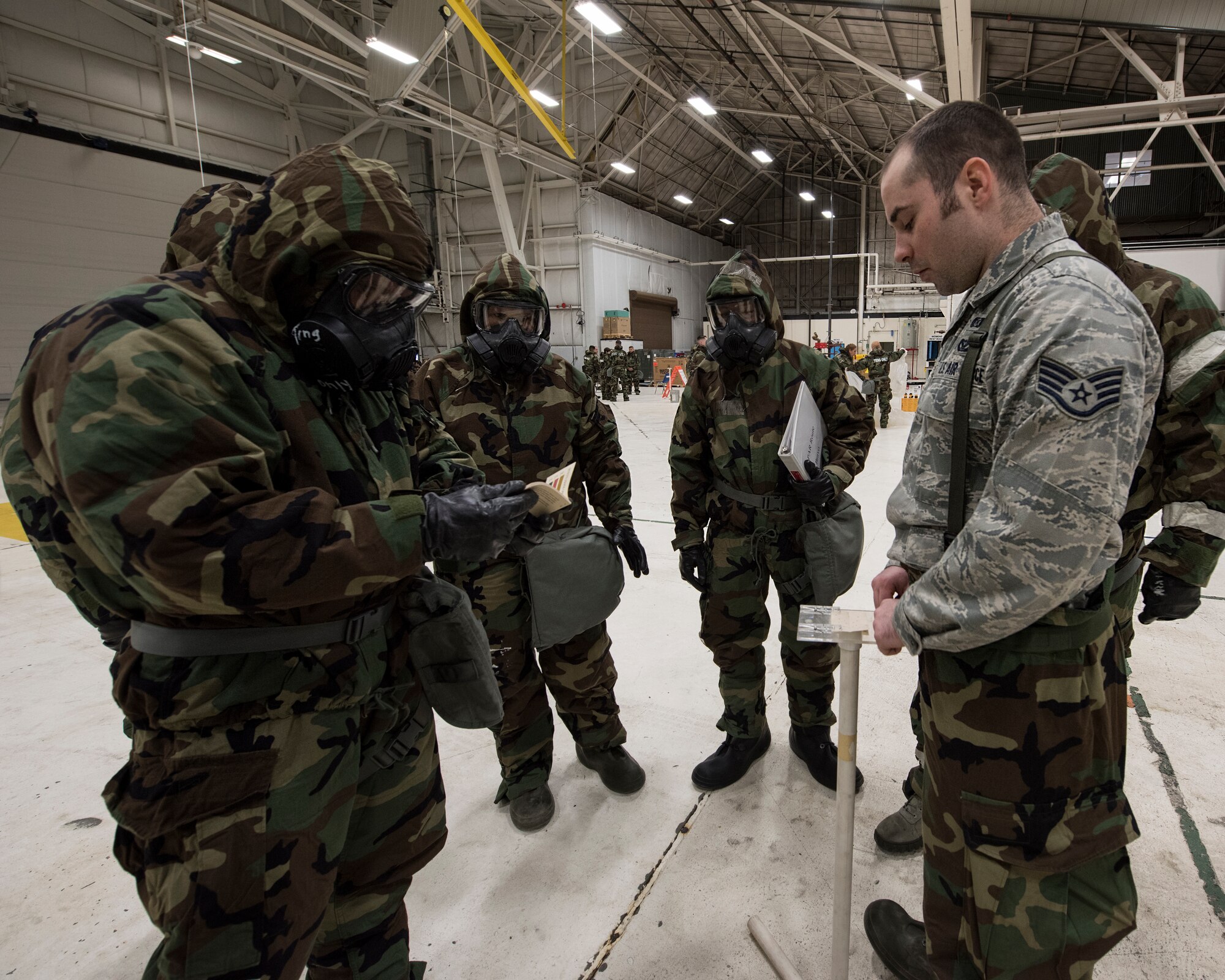 Staff Sgt. Nicholas Pinque, an emergency management journeyman with the 141st Civil Engineer Squadron, reviews proper procedures to detect chemical agents using M8 chemical detection paper during Chemical, Biological, Radiological, Nuclear Defense training March 6, 2018 at Fairchild Air Force Base, Wash. M8 paper is used to detect nerve and blister chemical agents and reacts by changing color to yellow, red, or black, depending on the chemical present. (U.S. Air National Guard photo by Staff Sgt. Rose Lust)