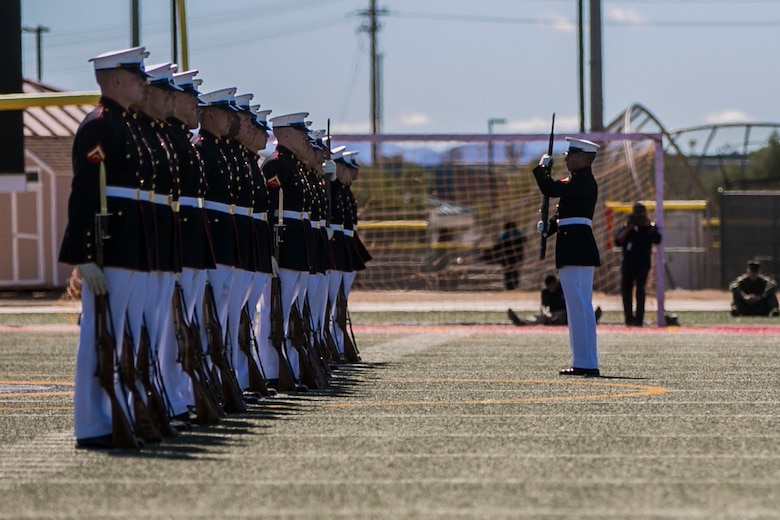 The U.S Marine Corps Silent Drill Platoon, Battle Colors Detachment, Marine Barracks Washington, D.C., performs during the Battle Colors Ceremony at Felix Field aboard the Marine Corps Air Ground Combat Center, Twentynine Palms, Calif., March 14, 2018. The ceremony is held to honor Marine Corps traditions through the Drum Corps, the Silent Drill Platoon and the Battle Colors Detachment.