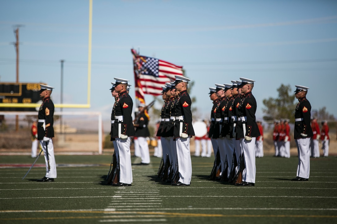 The U.S. Marine Corps Silent Drill Platoon, Battle Colors Detachment, Marine Barracks Washington, D.C., stands in formation as the colors are presented during the Battle Colors Ceremony at Felix Field aboard Marine Corps Air Ground Combat Center, Twentynine Palms, Calif., March 14, 2018. The ceremony is held to honor Marine Corps traditions through the Drum Corps, the Silent Drill Platoon and the Battle Colors Detachment.