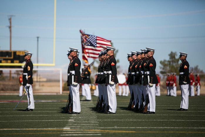 The U.S. Marine Corps Silent Drill Platoon, Battle Colors Detachment, Marine Barracks Washington, D.C., stands in formation as the colors are presented during the Battle Colors Ceremony at Felix Field aboard Marine Corps Air Ground Combat Center, Twentynine Palms, Calif., March 14, 2018. The ceremony is held to honor Marine Corps traditions through the Drum Corps, the Silent Drill Platoon and the Battle Colors Detachment.