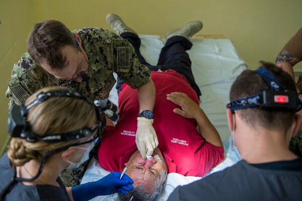 Military doctors remove a cancerous cyst from a Honduran man's nose.