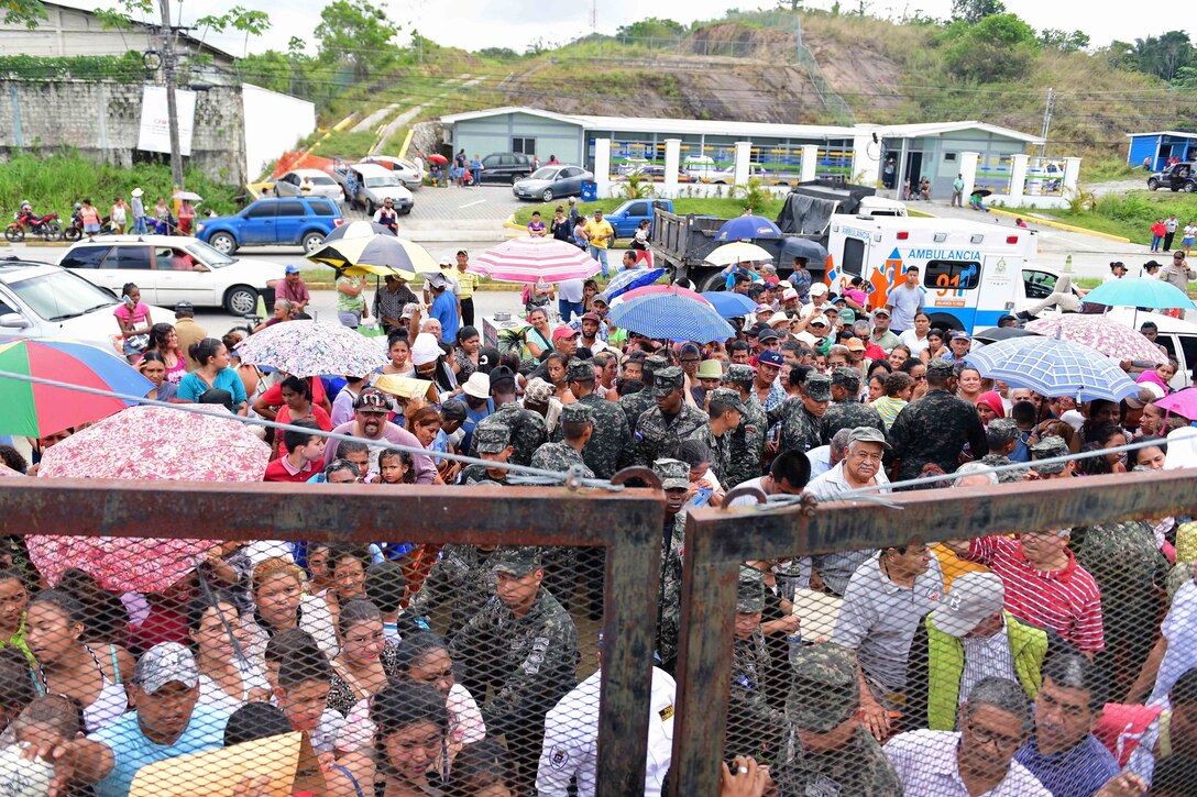 Hondurans wait in line to be seen by medical personnel.