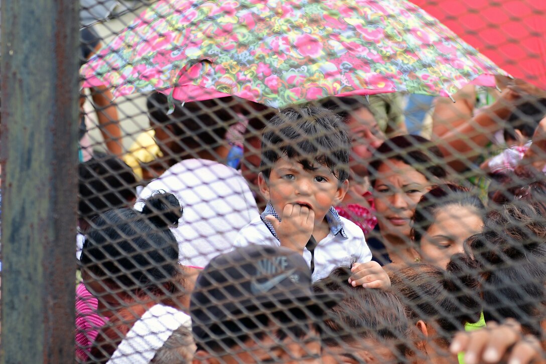 Hondurans wait in line to be seen by a medical team