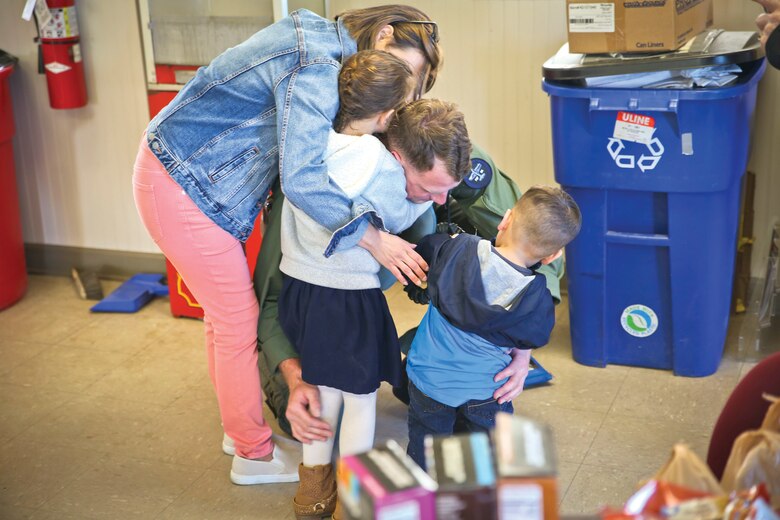 A Marine hugs his family aboard Marine Corps Air Station Beaufort, March 9.