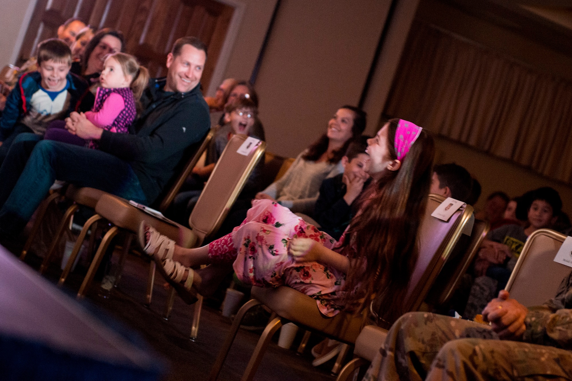 Audience members laugh at a joke performed by Ryan Bomgardner, ventriloquist, during his comedy show, March 15, 2018, at Moody Air Force Base, Ga. Air Force Entertainment provided this opportunity for Airmen to attend as a family to enjoy some time away from the mission. Bomgardner is a full-time ventriloquist and comedian who performs over 140 shows annually throughout North America. (U.S. Air Force photo by Airman 1st Class Erick Requadt)