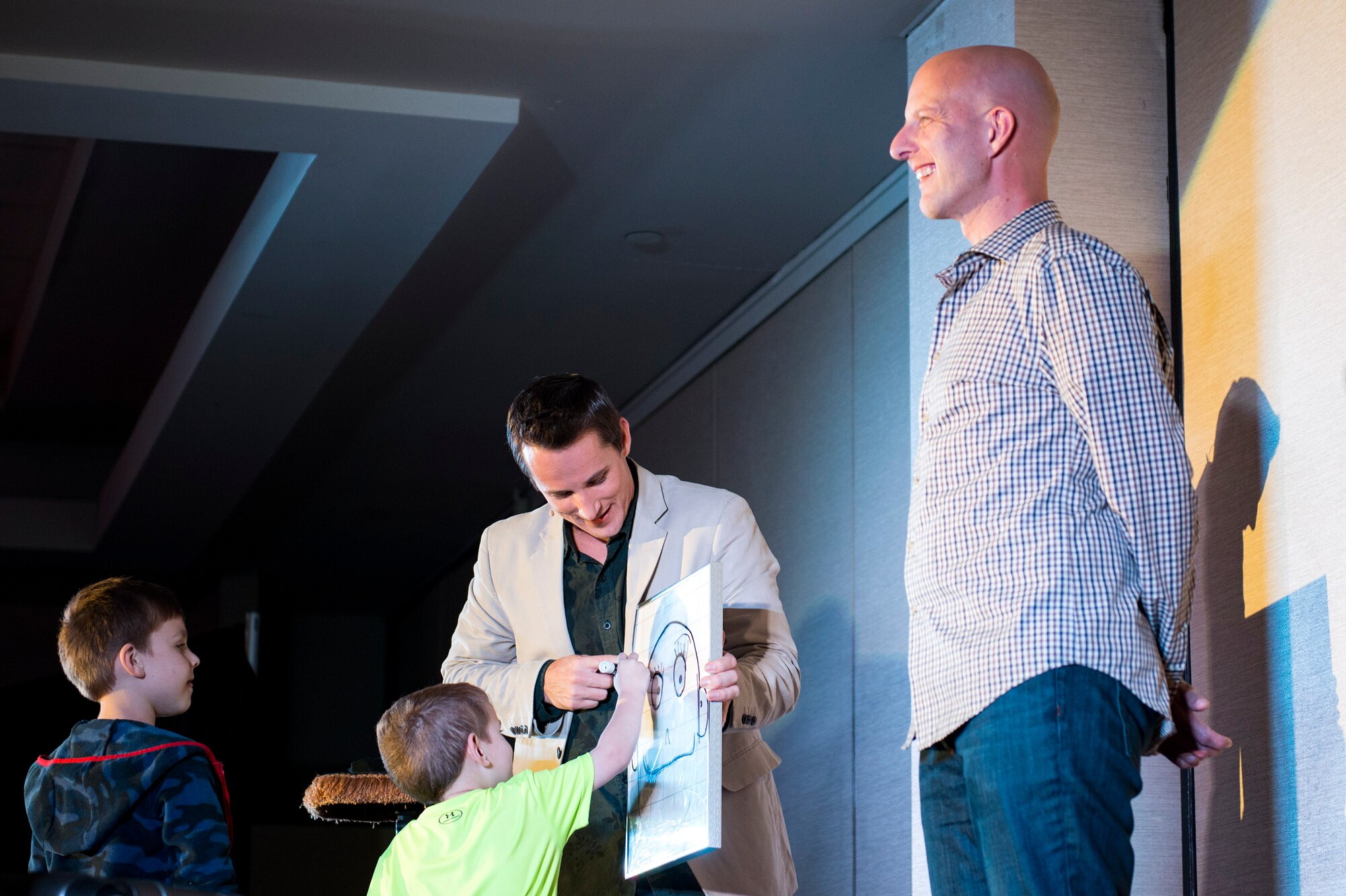 Ryan Bomgardner, ventriloquist, performs a skit with ‘Hanz the Drawing Board’ while involving audience members during his comedy show, March 15, 2018, at Moody Air Force Base, Ga. Air Force Entertainment provided this opportunity for Airmen to attend as a family to enjoy some time away from the mission. Bomgardner is a full-time ventriloquist and comedian who performs over 140 shows annually throughout North America. (U.S. Air Force photo by Airman 1st Class Erick Requadt)