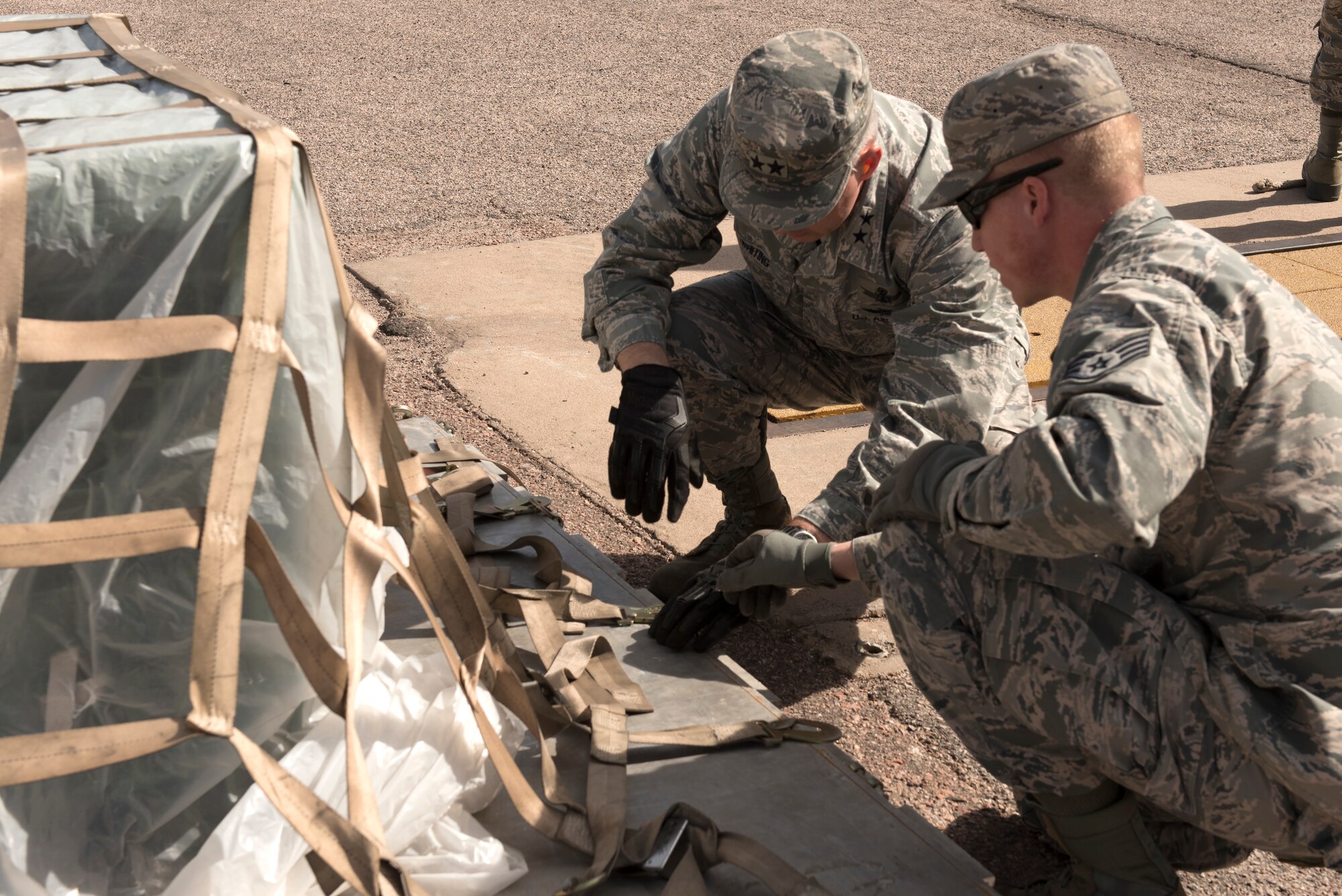 PETERSON AIR FORCE BASE, Colo. – Maj. Gen. Stephen Whiting, 14th Air Force commander, toured the 21st Logistics Readiness Squadron Peterson Air Force Base Colo., March 14, 2018. Whiting participated in the securing and the loading of freight. (U.S. Air Force photo by Cameron Hunt)