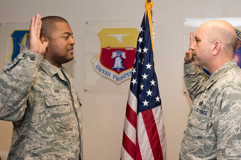 U.S. Air Force Reserve Senior Airman David Roby, a 913th Maintenance Squadron crew chief, signs re-enlistment paperwork Mar. 16, 2018, at Little Rock Air Force Base, Ark. The re-enlistment oath was administered by Lt. Col. Paul Centinaro, the commander of the 913th MXS. (U.S. Air Force photo by Master Sgt. Jeff Walston/Released)