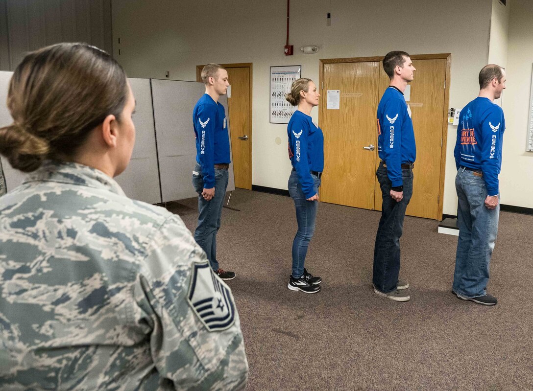 Master Sgt. Jana Schmidt, 934th Airlift Wing recruiter, calls out facing movements to trainees Chase Schmidt, Sara Syverhus, Jeffrey Metcalf and Robin Moore. (Air Force Photo/Paul Zadach)