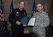 Col. Tony Polashek, 934th Airlift Wing commander, presents Minneapolis airport Police Sgt. Scott Morrison with a commander's coin and letter of appreciation March 6. Morrison was instrumental in assuring safe and efficient travel for Medal of Honor recipients and members of the Air Force Heritage Flight Team to Super Bowl LII and base events. (Air Force Photo/Paul Zadach)