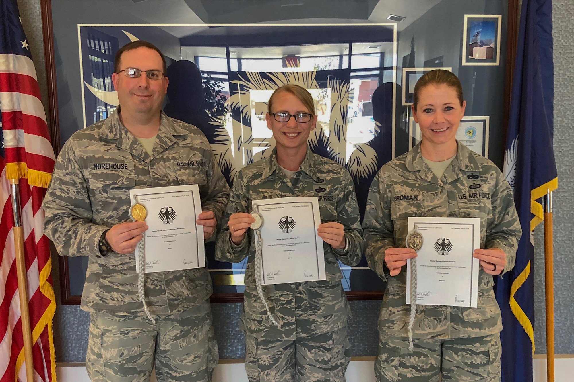 U.S. Air Force Senior Master Sgt. Matthew Morehouse, Master Sgt. Leeann Melton and Master Sgt. Wendy Broman, assigned to the South Carolina Air National Guard's 169th Fighter Wing, recieved the Schutzenschnur Badge for demonstrating profeciency in firing German weapons, March 7, 2018 at McEntire Joint National Guard Base, S.C. Several other service members were chosen to participate in a specialized training opportunity to work with German soldiers. They learned how to fire a German rifle, pistol and machine gun. (U.S. Air National Guard courtesy photo)
