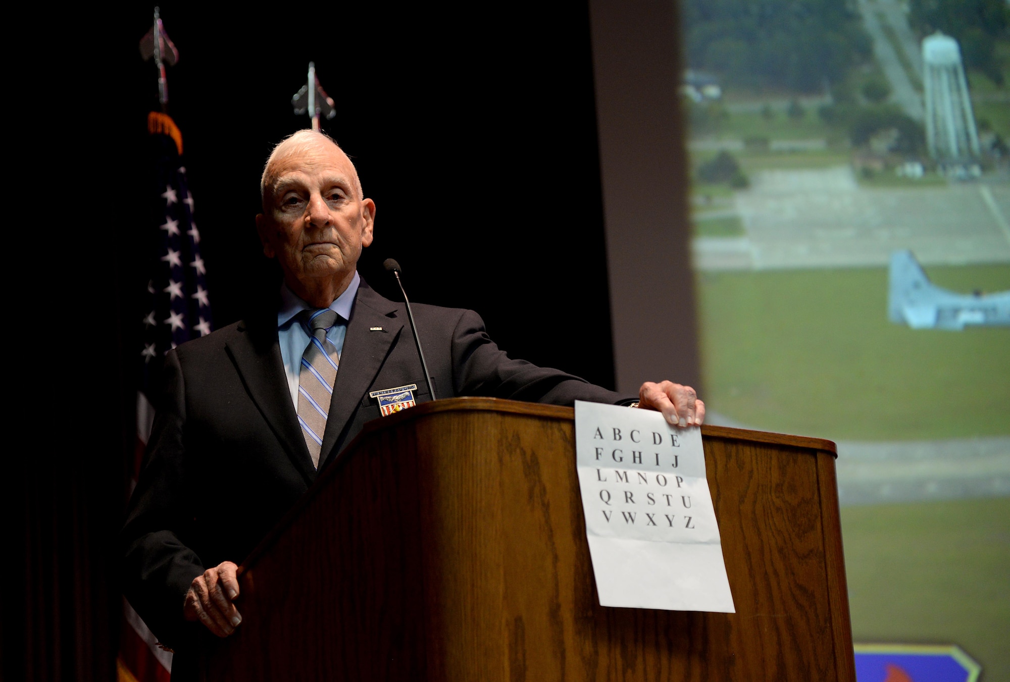 Retired Col. Carlyle “Smitty” Harris, former Vietnam War prisoner of war, speaks to Specialized Undergraduate Pilot Training Class 18-06’s graduation audience about the TAP code March 9, 2018, on Columbus Air Force Base, Mississippi. He spoke to the class about his time as a POW and recounted how his success throughout his life came from the same attributes the pilots have and will continue developed throughout their training. (U.S. Air Force photo by Airman 1st Class Keith Holcomb)