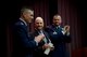 Col. Douglas Gosney, 14th Flying Training Wing commander, and Col. Stanley Lawrie, 14th Operations Group Commander, give retired Col. Carlyle “Smitty” Harris, former Vietnam War prisoner of war, a standing ovation after his graduation speech to Specialized Undergraduate Pilot Training Class 18-06 March 9, 2018, on Columbus Air Force Base, Mississippi. Harris spent 2,871 days in Vietnam as a POW after being shot down April 4, 1965.(U.S. Air Force photo by Airman 1st Class Keith Holcomb)