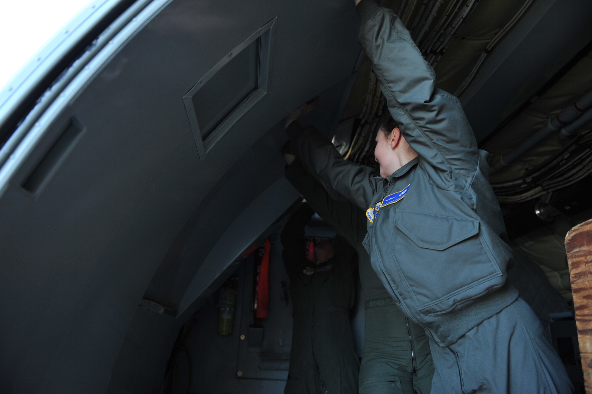 Senior Airman Baila Kunesova, 22nd Aircraft Maintenance Squadron avionics journeyman and assistant crew chief installs a decoration door for the static display at the Girls Fly Too event March 11-12 at Abbotsford International Airport, Abbotsford, British Columbia, Canada. The crew, which included three pilots, two crew chiefs and two boom operators, attended to showcase the KC-135 Stratotanker and inspire future generations of women to pursue aviation careers.