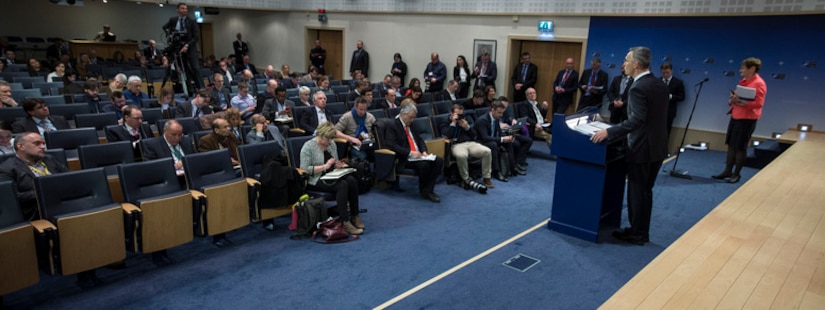 NATO secretary general speaks at a lectern at NATO headquarters.