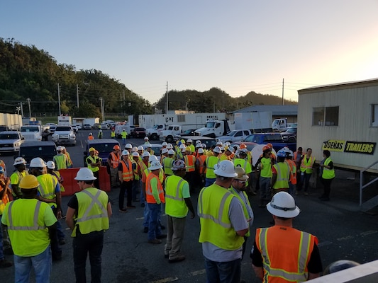 Contractors outside the Incident Support Base (ISB) at Ft. Buchanan receiving the morning assignments on 13 March 2018.