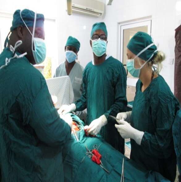 (Wearing glasses) Airman 1st Class Maxwell Ali, an aerospace technician for the 319th Medical Operations Support Squadron, assists with a cesarean section at Bukovinian State Medical University in Chernivsti, Ukraine Sept. 14, 2014. Ali was in the middle of his internship in medical school. (Courtesy photo)