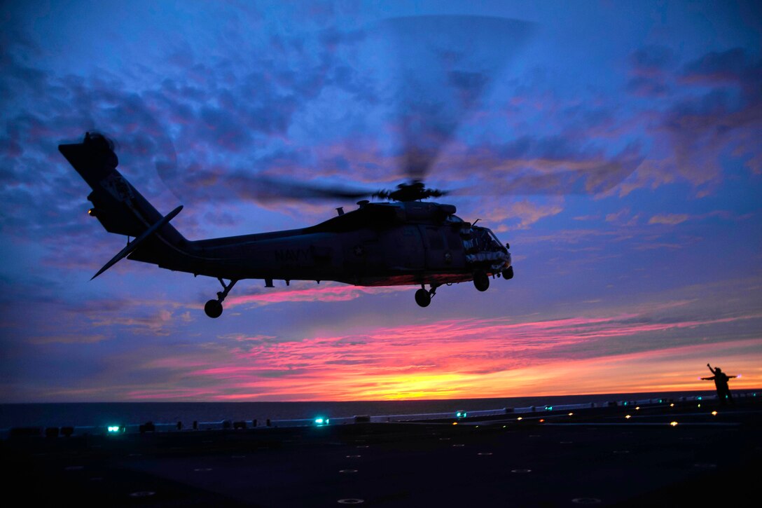 An MH-60S Seahawk helicopter takes off.
