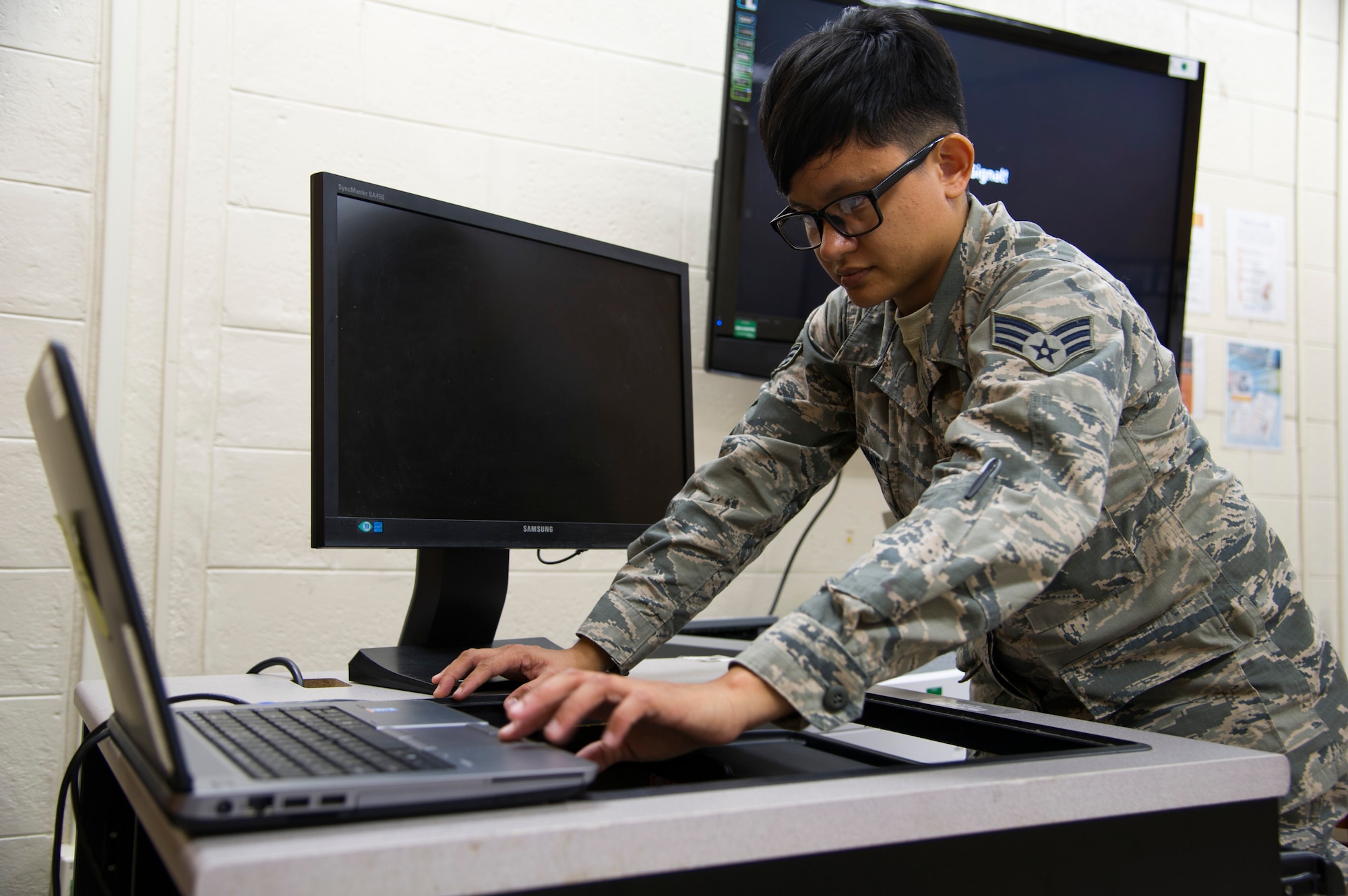 U.S. Air Force Senior Airman Jamie Matanane, a Reserve Citizen Airman with the 624th Regional Support Group Knowledge Operations Management alternate operating location in Guam, tests newly installed electronic components during a rebuild for an outdated testing station March 9, 2018, at Andersen Air Force Base, Guam. Five testing stations, which are used for individual Professional Military Education and career field upgrade testing, were rebuilt and restored to improve 624th RSG Test Control Office capabilities and sustainability for Reserve Citizen Airmen in Guam. (U.S. Air Force photo by Jerry R. Bynum)