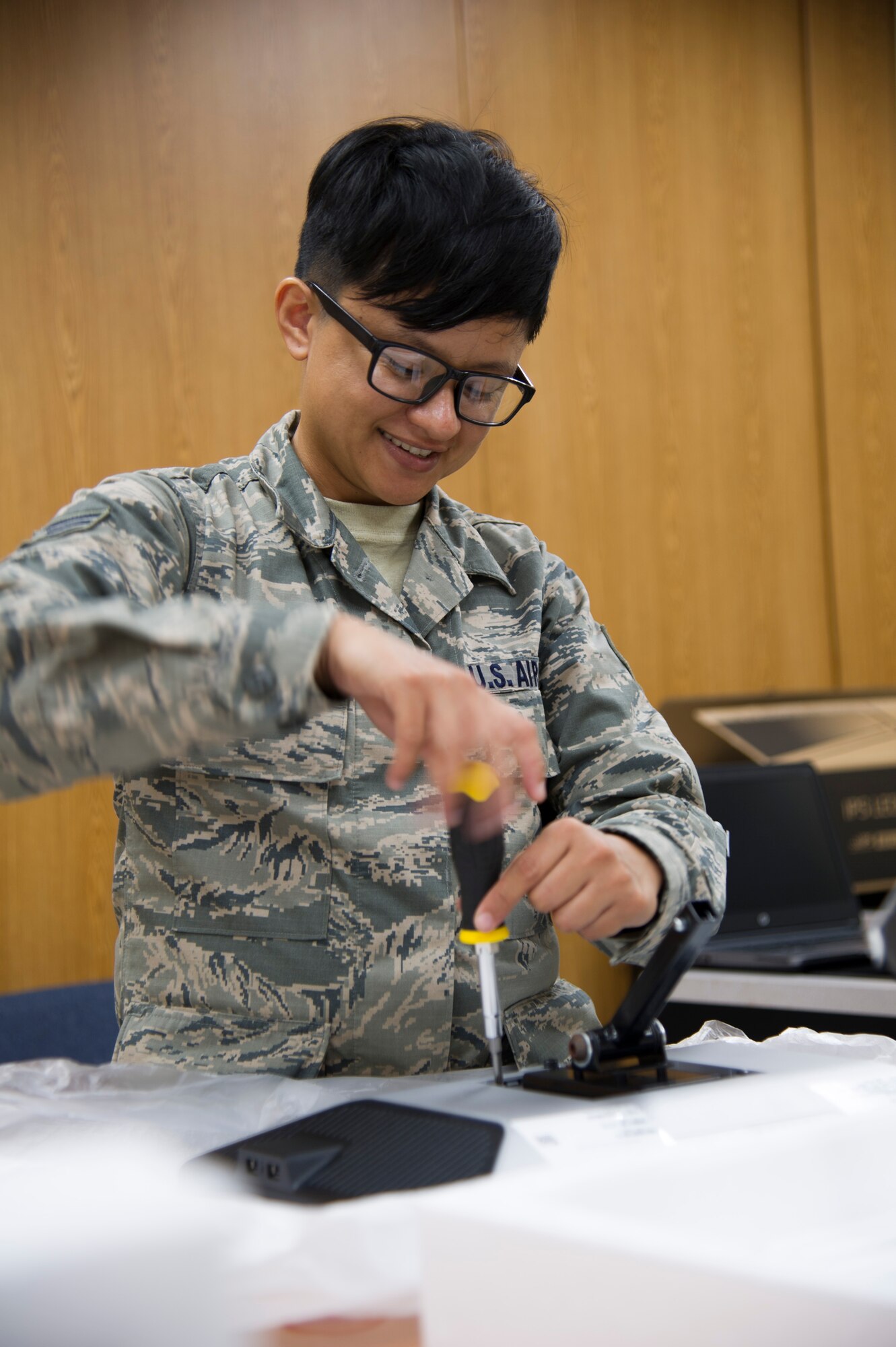 U.S. Air Force Senior Airman Jamie Matanane, a Reserve Citizen Airman with the 624th Regional Support Group Knowledge Operations Management alternate operating location in Guam, installs a computer monitor bracket as part of a rebuild for an outdated testing station March 9, 2018, at Andersen Air Force Base, Guam. Five testing stations, which are used for individual Professional Military Education and career field upgrade testing, were rebuilt and restored to improve 624th RSG Test Control Office capabilities and sustainability for Reserve Citizen Airmen in Guam. (U.S. Air Force photo by Jerry R. Bynum)