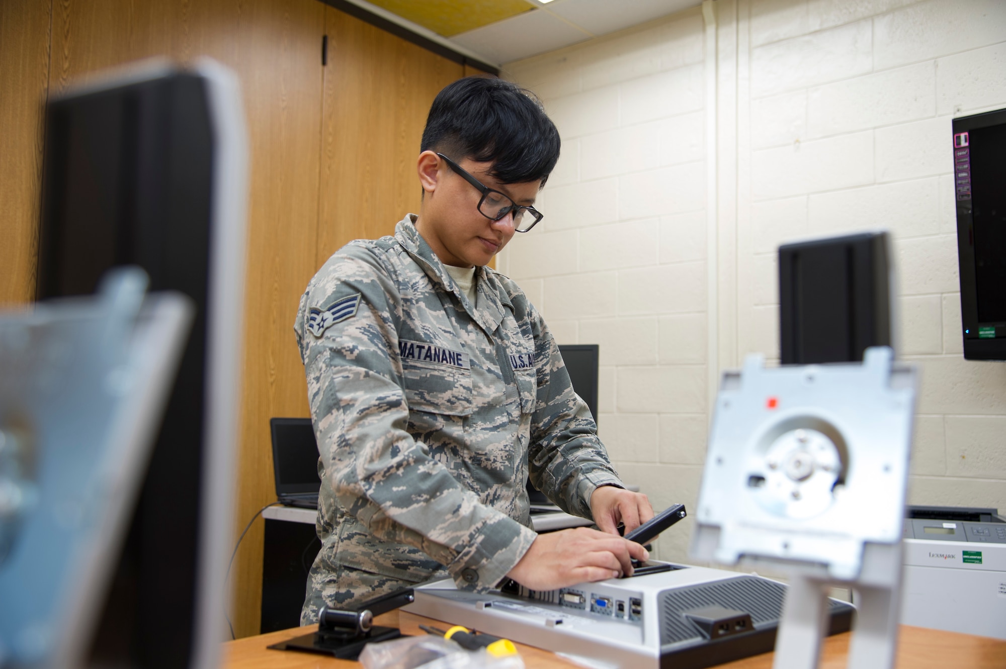 U.S. Air Force Senior Airman Jamie Matanane, a Reserve Citizen Airman with the 624th Regional Support Group Knowledge Operations Management alternate operating location in Guam, installs a computer monitor bracket as part of a rebuild for an outdated testing station March 9, 2018, at Andersen Air Force Base, Guam. Five testing stations, which are used for individual Professional Military Education and career field upgrade testing, were rebuilt and restored to improve 624th RSG Test Control Office capabilities and sustainability for Reserve Citizen Airmen in Guam. (U.S. Air Force photo by Jerry R. Bynum)