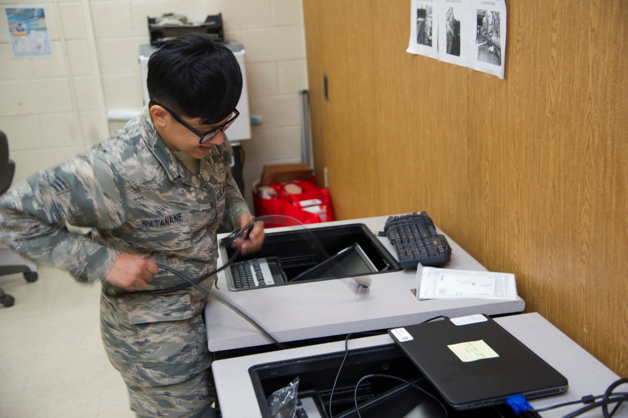 U.S. Air Force Senior Airman Jamie Matanane, a Reserve Citizen Airman with the 624th Regional Support Group Knowledge Operations Management alternate operating location in Guam, installs a new power supply as part of a rebuild for an outdated testing station March 9, 2018, at Andersen Air Force Base, Guam. Five testing stations, which are used for individual Professional Military Education and career field upgrade testing, were rebuilt and restored to improve 624th RSG Test Control Office capabilities and sustainability for Reserve Citizen Airmen in Guam. (U.S. Air Force photo by Jerry R. Bynum)