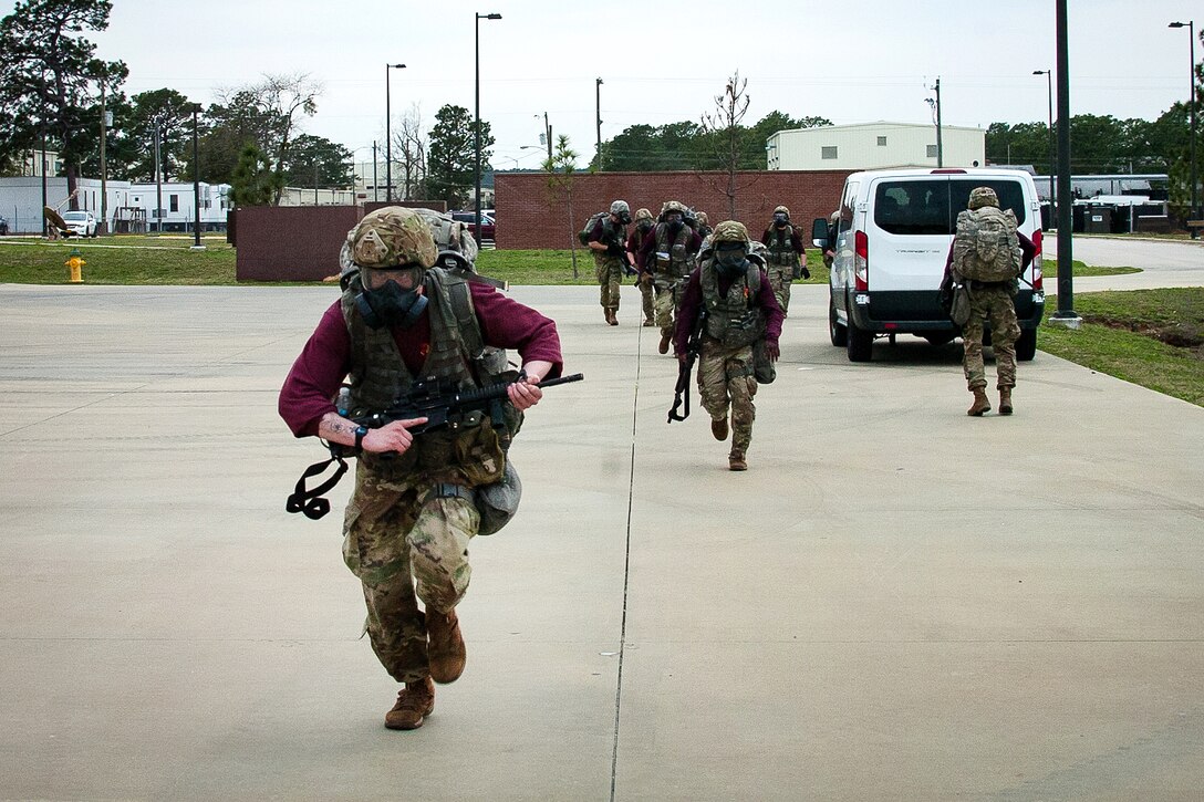 Soldiers finish a timed ruck march.