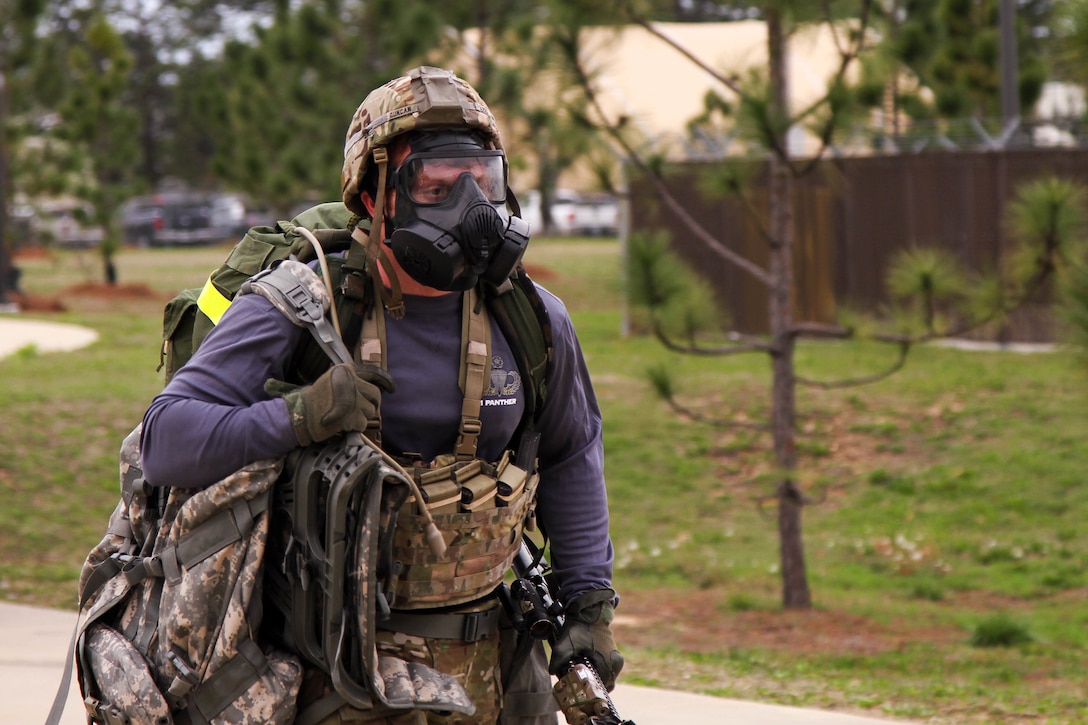 A soldier finishes a timed ruck march.