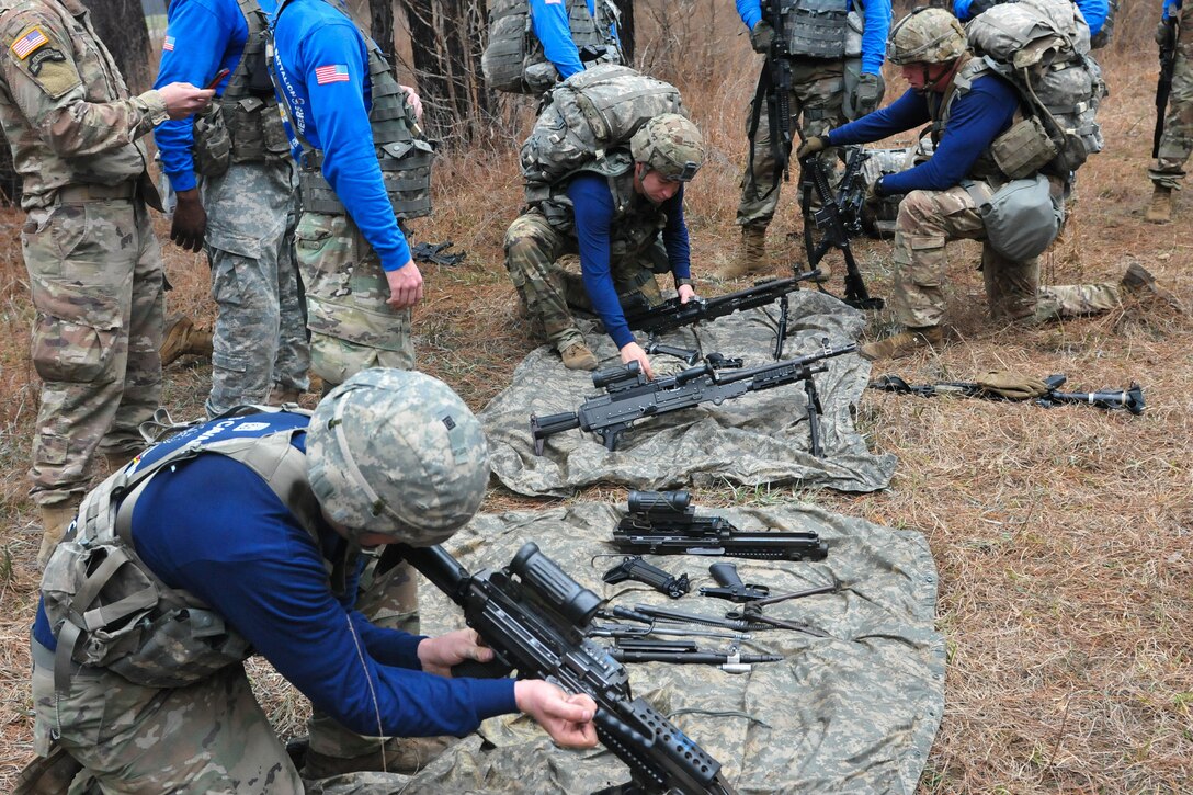 Soldiers disassemble and assemble and variety of weapons.
