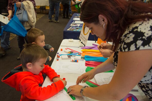 Jaxon and Kastor Clippinger make paper balloons with Maria Loveless, Applied Behavior Connections, at the Special Needs Summit March 15, 2018, at Hill Air Force Base, Utah. (U.S. Air Force photo by Airman 1st Class James Kennedy)