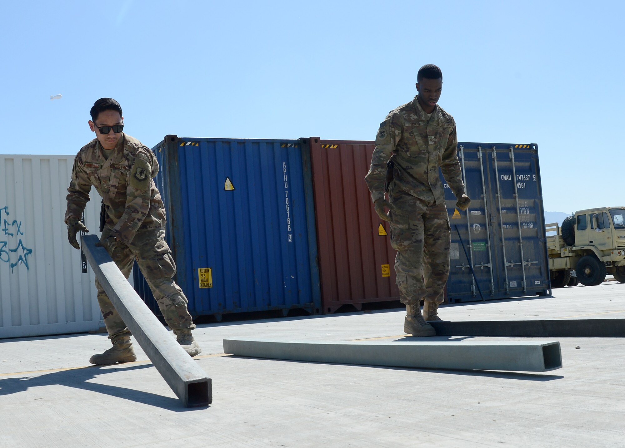 Staff Sgt. Josiah McDonald (left), 455th Expeditionary Logistic Readiness Squadron in-bound cargo NCOIC, and Senior Airman Trevis Pridgen (right), 455th ELRS traffic management technician, lay dunnage for cargo Mar. 16, 2018 at Bagram Airfield, Afghanistan.