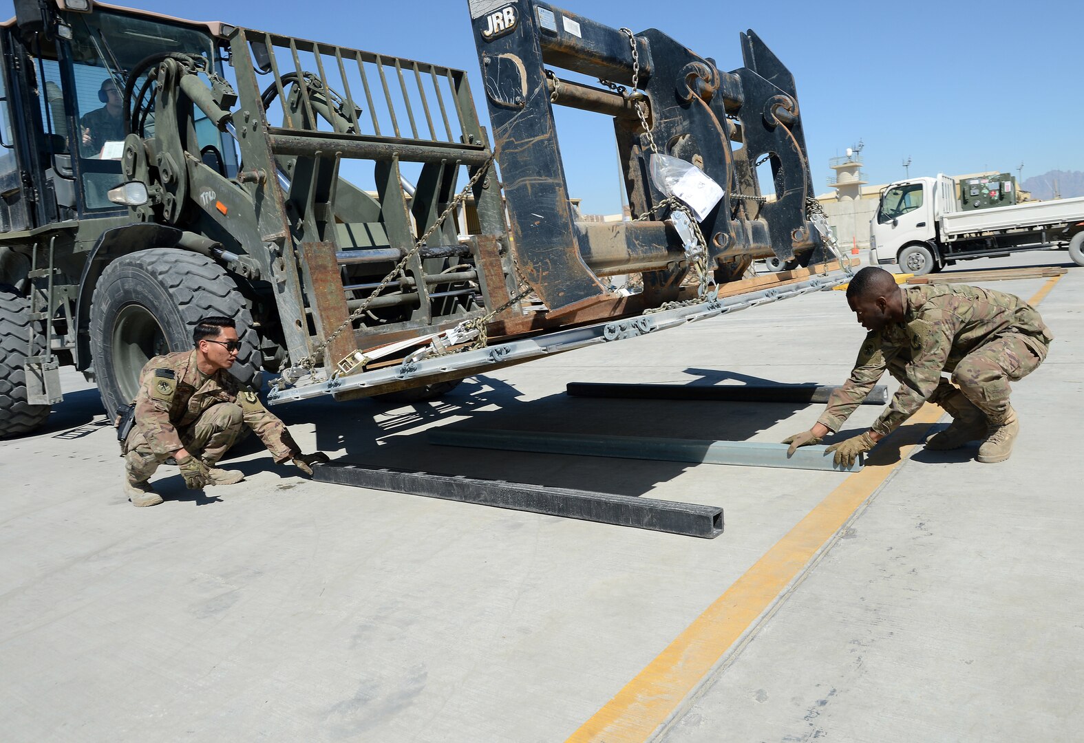 Staff Sgt. Josiah McDonald (left), 455th Expeditionary Logistic Readiness Squadron in-bound cargo NCOIC, and Senior Airman Trevis Pridgen (right), 455th ELRS traffic management technician, lay dunnage for cargo Mar. 16, 2018 at Bagram Airfield, Afghanistan.