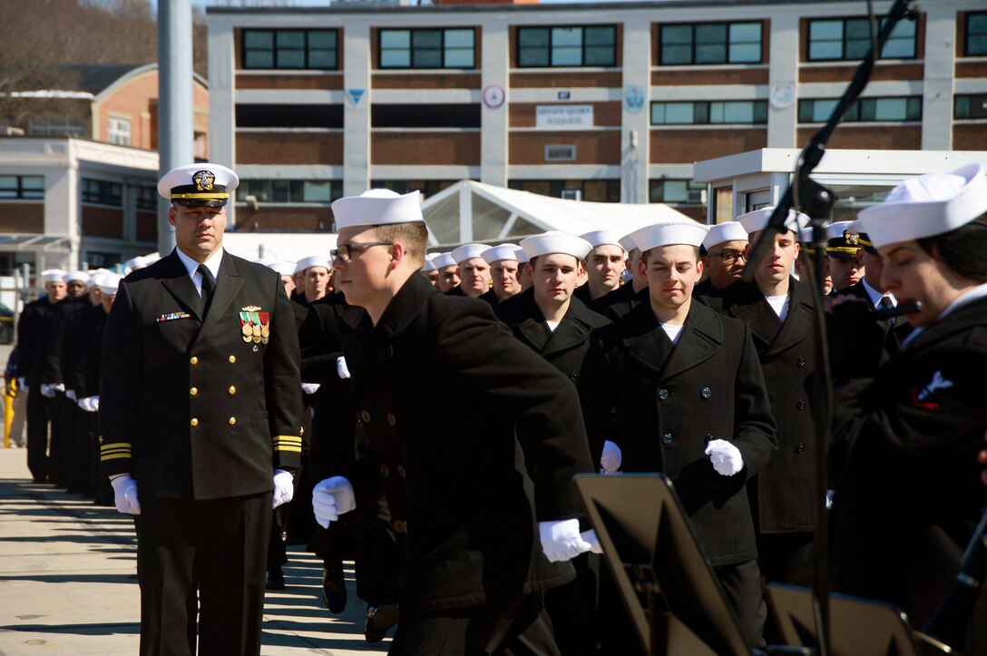 Sailors line up aboard a ship.