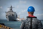 180319-N-YG104-0001 OKINAWA, Japan (March 19, 2018) A Sailor looks on as the dock landing ship USS Ashland (LSD 48) departs the harbor of White Beach Naval Facility after embarking the 31st Marine Expeditionary Unit. Ashland, part of the Wasp Expeditionary Strike Group, is operating in the Indo-Pacific region as part of a regularly scheduled patrol and provides a rapid-response capability in the event of a regional contingency or natural disaster. (U.S. Navy photo by Mass Communication Specialist 2nd Class Sarah Villegas/ Released)