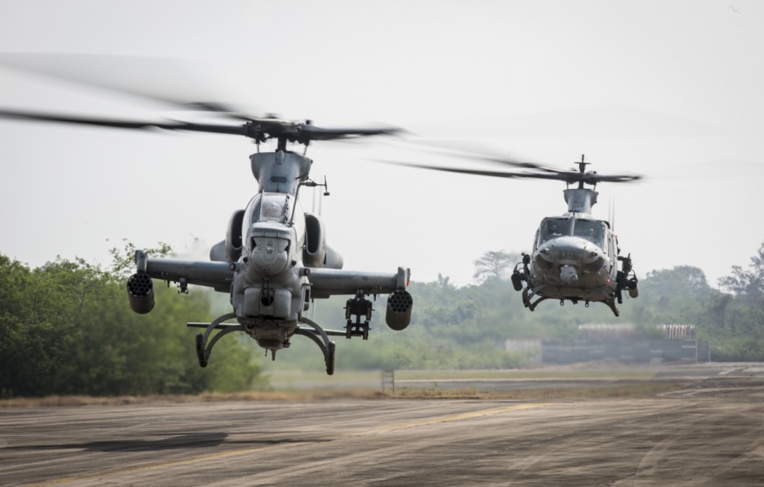 A U.S. Marine Corps AH-1Z Viper helicopter, foreground, and a UH-1Y Venom helicopter lift off the runway at U-Tapao International Airport, Kingdom of Thailand, Feb. 10, 2018. Marine Light Attack Helicopter Squadron 369 arrived in Thailand to participate in the 37th iteration of Cobra Gold as part of the U.S. Marine Corps Aviation Combat Element. HMLA-369, Marine Aircraft Group 39, 3rd Marine Aircraft Wing, is currently forward-deployed under the unit deployment program with MAG-36, 1st MAW. Exercise Cobra Gold 2018 is an annual exercise conducted in the Kingdom of Thailand held from Feb. 13-23 with seven full participating nations. (U.S. Marine Corps photo by Cpl. Andy Martinez)