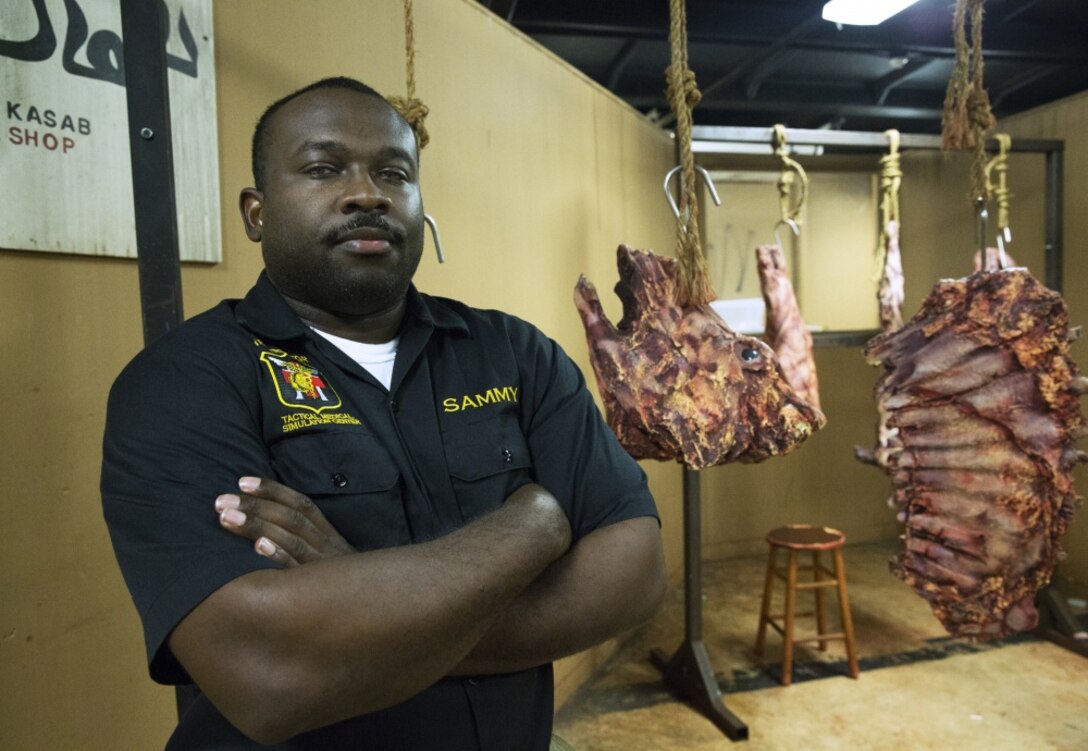 Petty Officer 1 Marlon Sammy, the 1st Marine Aircraft Wing representative for the Tactical Medical Simulation Center, poses in front of an exhibit, Feb. 16, 2018, Camp Hansen, Okinawa, Japan.