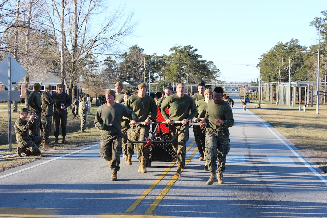 On March 15, 2018 Marine Corps Engineer School (MCES) hosted the annual St. Patrick’s Day Engineer Field Meet to pay homage to St. Patrick, the patron saint for engineers; build camaraderie amongst the engineer and utility communities, and compete for the Engineer Field Meet Trophy.  This year there were five units that competed in Marine, engineer, and utility themed events:  MCES, Marine Wing Support Squadron-274 (MWSS-274), Combat Logistics Battalion-2 (CLB-2), 8th Engineer Support Battalion (8th ESB), and 2d Combat Engineer Battalion (2d CEB). Pictured is the MCES Chariot Race team.