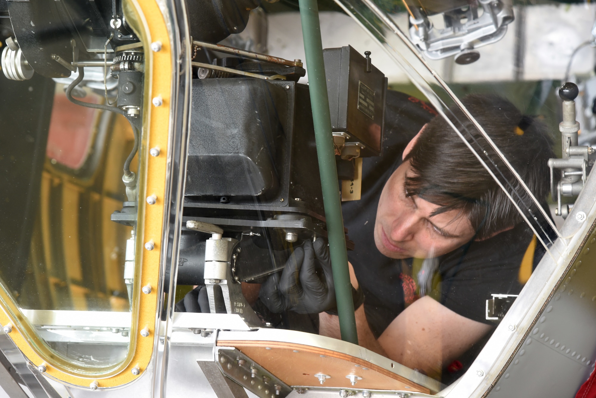 (03/09/2018) -- Museum restoration specialist Casey Simmons installs a bomb sight in the Boeing B-17F Memphis Belle. Plans call for the aircraft to be placed on permanent public display in the WWII Gallery here at the National Museum of the U.S. Air Force on May 17, 2018. (U.S. Air Force photo by Ken LaRock)