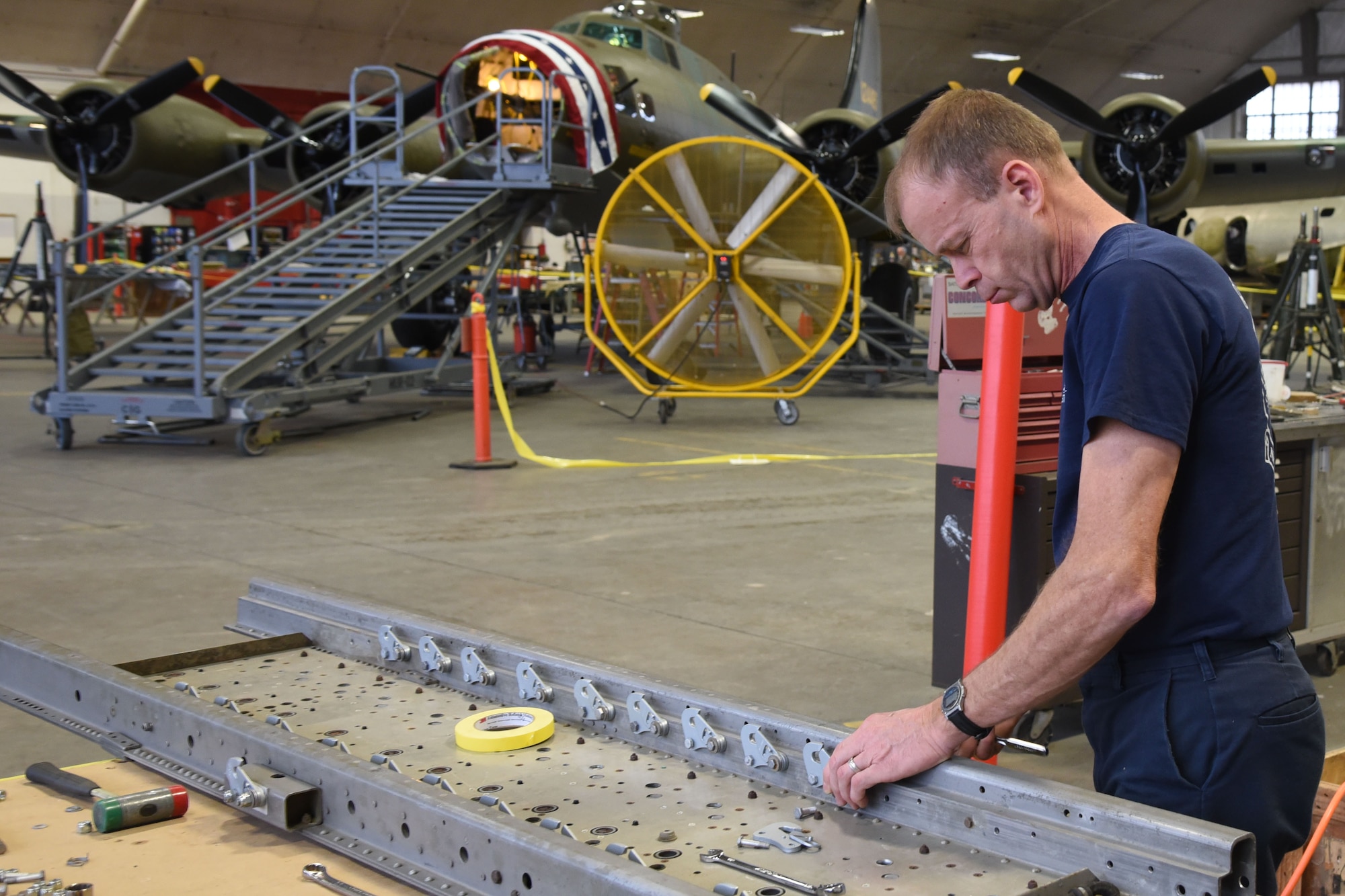 (02/22/2018) -- Museum restoration specialist Brian Lindamood works on the bomb racks of the Boeing B-17F Memphis Belle. Plans call for the aircraft to be placed on permanent public display in the WWII Gallery here at the National Museum of the U.S. Air Force on May 17, 2018. (U.S. Air Force photo by Ken LaRock)