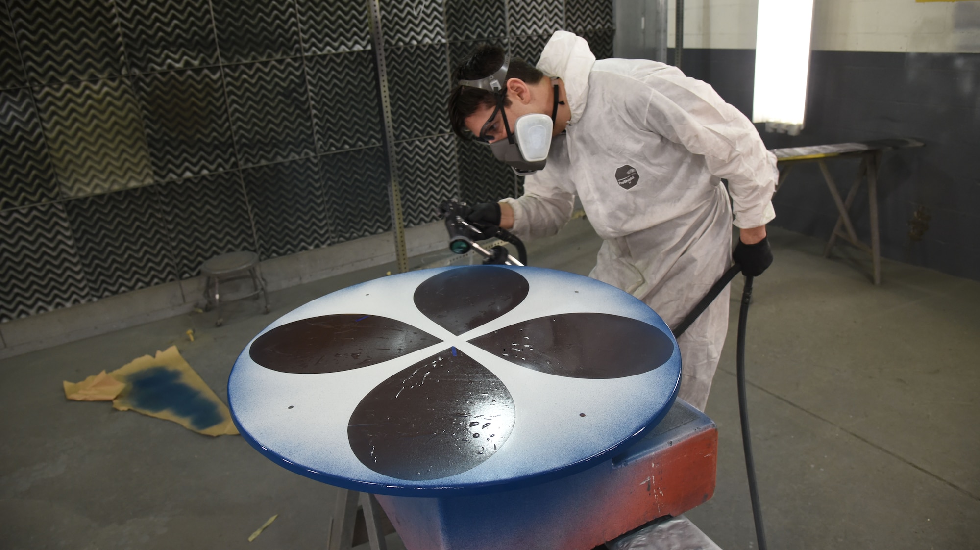 (02/22/2018) -- Museum restoration specialist Casey Simmons paints the wheel covers for the Boeing B-17F Memphis Belle. Plans call for the aircraft to be placed on permanent public display in the WWII Gallery here at the National Museum of the U.S. Air Force on May 17, 2018. (U.S. Air Force photo by Ken LaRock)