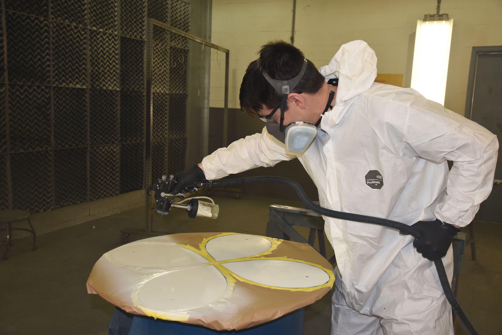 (02/22/2018) -- Museum restoration specialist Casey Simmons paints the wheel covers for the Boeing B-17F Memphis Belle. Plans call for the aircraft to be placed on permanent public display in the WWII Gallery here at the National Museum of the U.S. Air Force on May 17, 2018. (U.S. Air Force photo by Ken LaRock)
