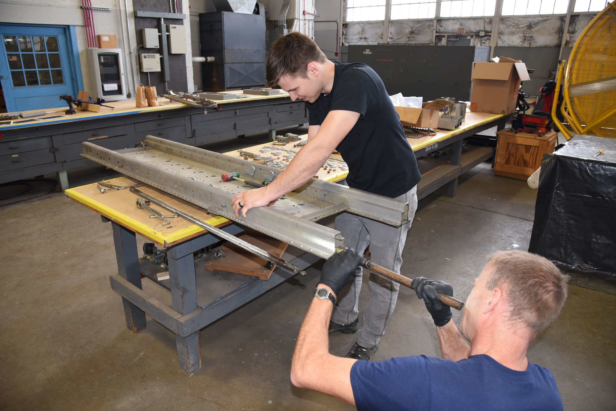 (02/22/2018) -- Museum restoration specialists Jason Davis and Brian Lindamood work on the bomb racks for the Boeing B-17F Memphis Belle. Plans call for the aircraft to be placed on permanent public display in the WWII Gallery here at the National Museum of the U.S. Air Force on May 17, 2018. (U.S. Air Force photo by Ken LaRock)