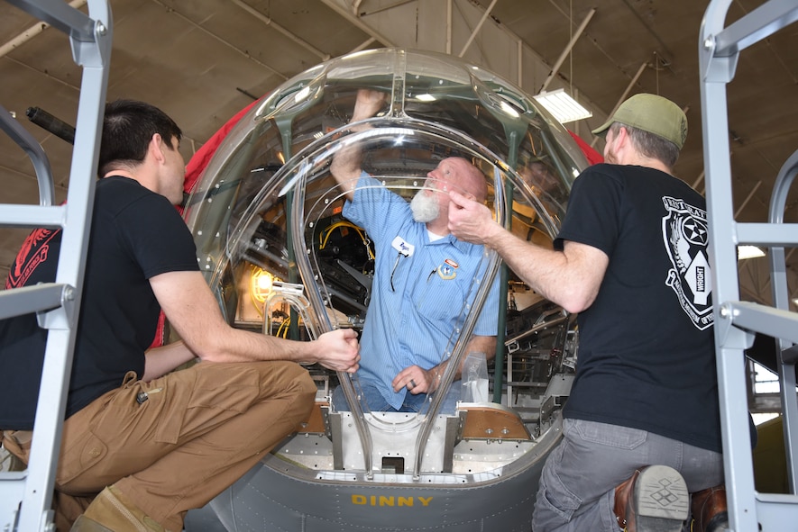 (02/26/2018) -- Museum restoration specialists Casey Simmons, Roger Brigner and Chad Vanhook attach the nose cone onto the Boeing B-17F Memphis Belle. Plans call for the aircraft to be placed on permanent public display in the WWII Gallery here at the National Museum of the U.S. Air Force on May 17, 2018. (U.S. Air Force photo by Ken LaRock)